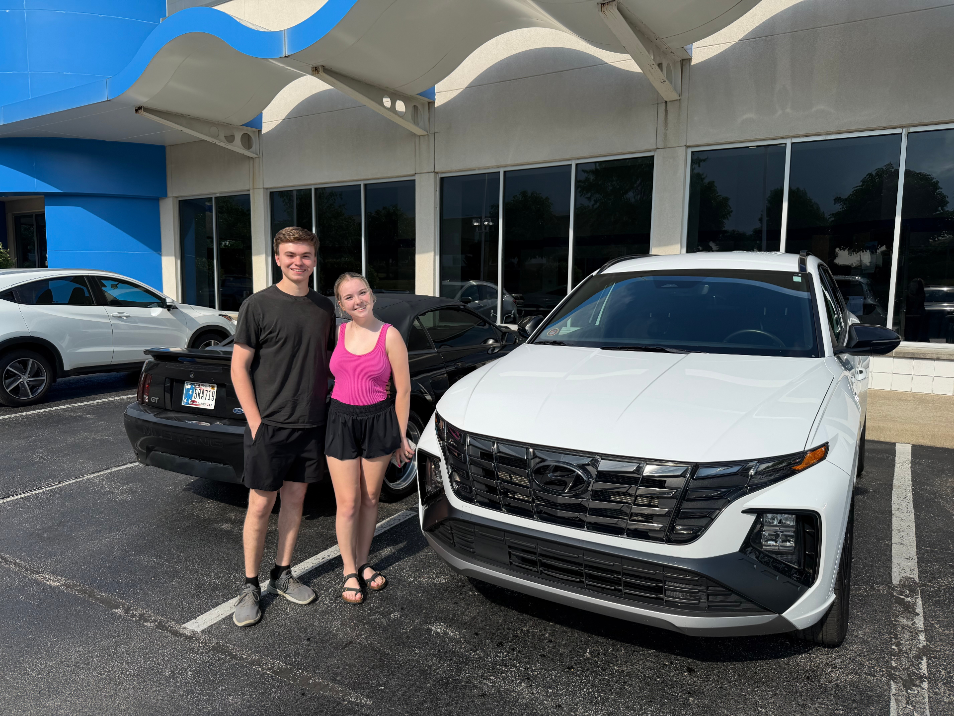 Young couple with their new vehicle